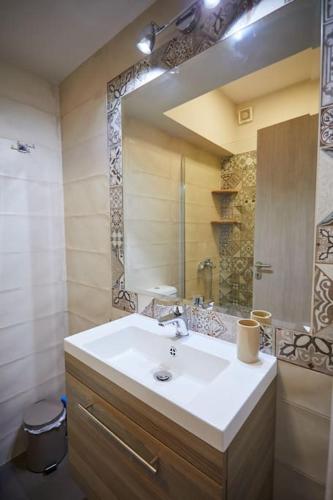 a bathroom with a sink and a mirror at Chioni's Houses in Chios