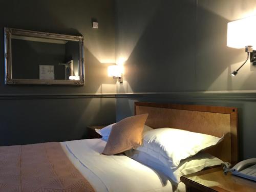 a bedroom with a bed with a mirror on the wall at Eurobar & Hotel in Oxford
