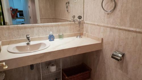 a bathroom with a sink and a mirror at Madrid Airport Apartments in Madrid