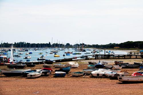 a bunch of boats sitting on the beach at Willow House B&B in West Wittering
