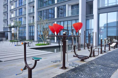 a row ofulptures of hearts on a sidewalk in front of a building at Hi-Home Suites - Vinhomes Metropolis in Hanoi