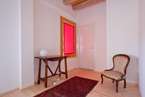 a room with a table and a chair and a window at Ca' Adami in Brussa