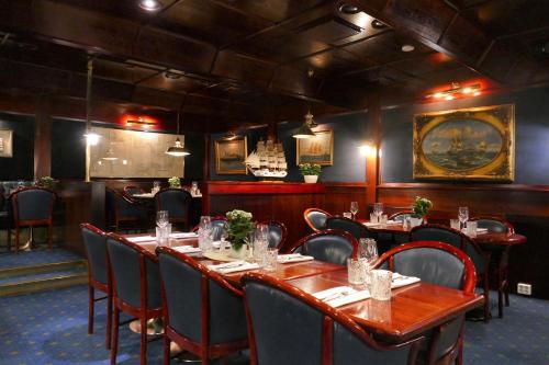 a dining room with tables and chairs and a painting on the wall at Hotel Kalliohovi - ilmastoidut huoneet - in Rauma