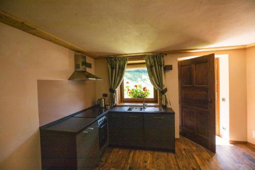 a kitchen with a sink and a window at Casa Vacanze Petit Haury - Alloggi ad uso turistico vda Arvier n 0039 e n 0040 - in Arvier