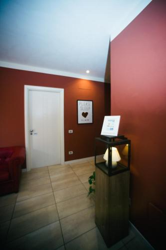 a room with a white door and a red wall at Locanda Cece e Simo in Bergamo