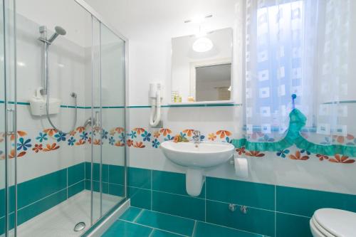 a bathroom with a sink and a glass shower at La Casetta in Agerola
