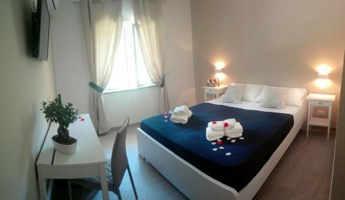 a bedroom with a bed with two stuffed animals on it at Cosmo Rooms a pochi passi da Tropea in Tropea
