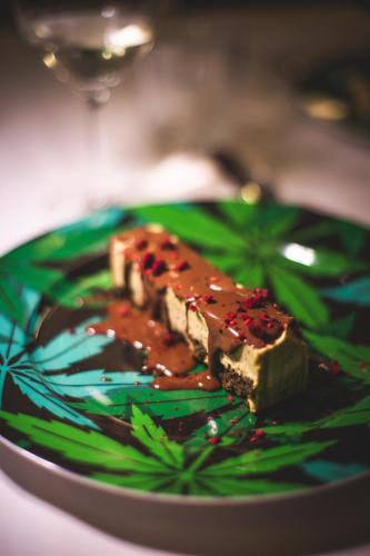 a piece of cake on a green plate with sauce at Locanda Cece e Simo in Bergamo