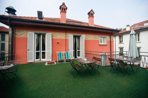 a patio with tables and chairs on a lawn at Locanda Cece e Simo in Bergamo