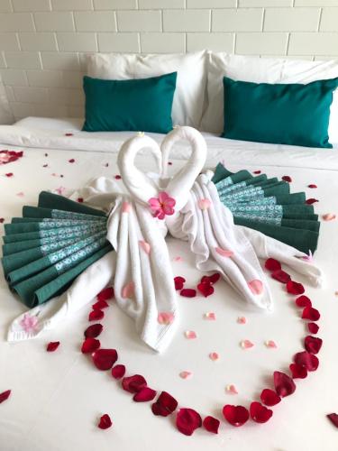 a bed with a heart made out of towels at Casa Tanjung Jara in Dungun