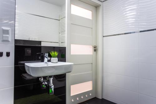 La salle de bains est pourvue d'un lavabo et d'un miroir. dans l'établissement Przy Mocaku, à Cracovie