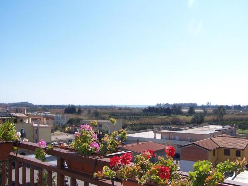 a view of a city from a balcony with flowers at Le Stanze di Patika in Tortolì