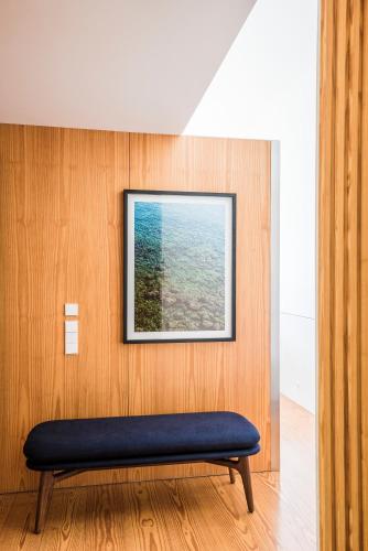 a bench in a room with a picture on the wall at Flattered to be in Porto in Porto