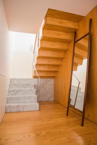 a wooden staircase in a room with wooden floors at Flattered to be in Porto in Porto