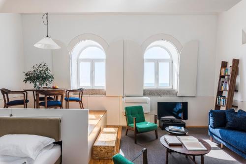 a living room with a couch and a table at Flattered to be in Porto in Porto