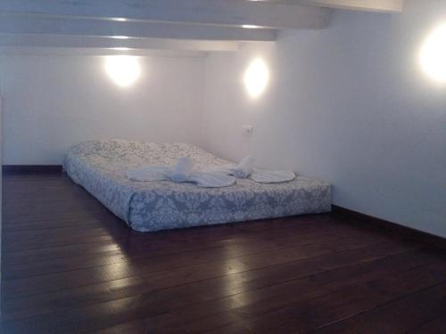 a bed in a room with two towels on it at House Galini in Halki