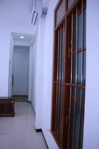 an empty room with a door and a hallway at Talalla 170 Villa in Talalla