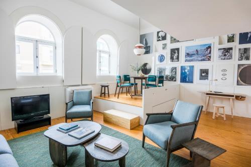 a living room with a couch and chairs and a tv at Flattered to be in Porto in Porto