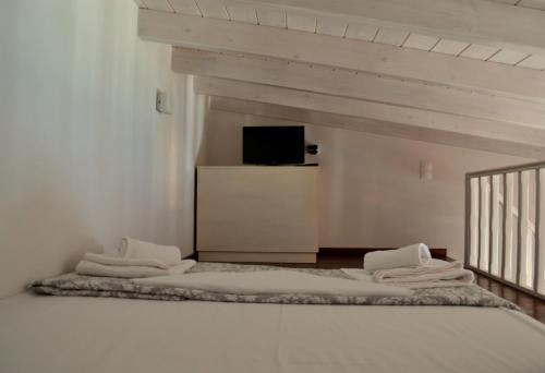 a room with two beds and a tv on a wall at House Galini in Halki