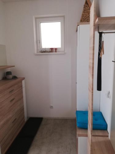 a small room with a window and a blue stool at Ferienhaus Hubertus Tirol 1-8 Personen in Pill