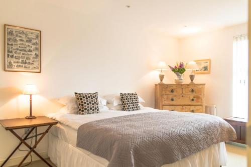 a bedroom with a bed with two pillows on it at Beach View, Waterside Cottages in Alnmouth
