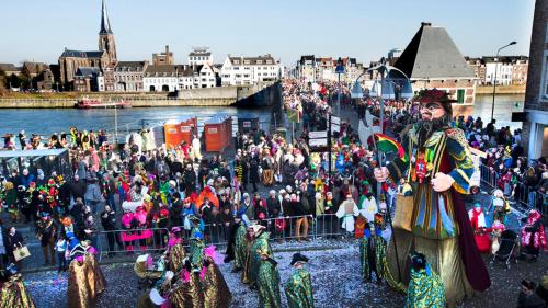 a large crowd of people watching a parade on a river at Holiday Home 'Beautifull Water' in Lanaken