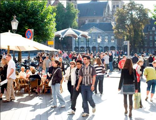 a crowd of people walking around in a city at Holiday Home 'Beautifull Water' in Lanaken