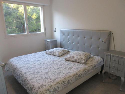 une chambre avec un lit avec deux oreillers dessus dans l'établissement VUE MER 3 mn A PIED DE LA PLAGE LUMINEUX ET MODERNE, à Bandol