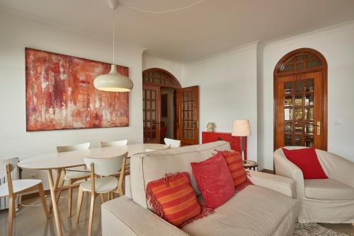 a living room with a couch and a table at Cascais Handsome Apartment in Cascais