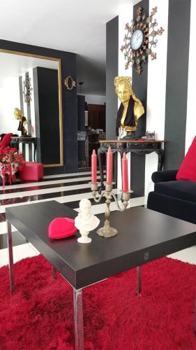 a living room with a black table and red rug at @Room Apartment in Ban Zong Katiam