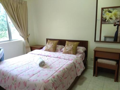 a bedroom with two beds and a mirror at Suria Apartment 1BEDROOM Bukit Merah in Simpang Ampat Semanggol
