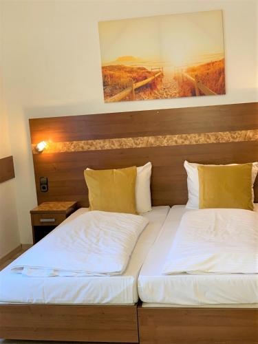 a pair of beds in a room at Hotel zum Adler in Bad Homburg vor der Höhe
