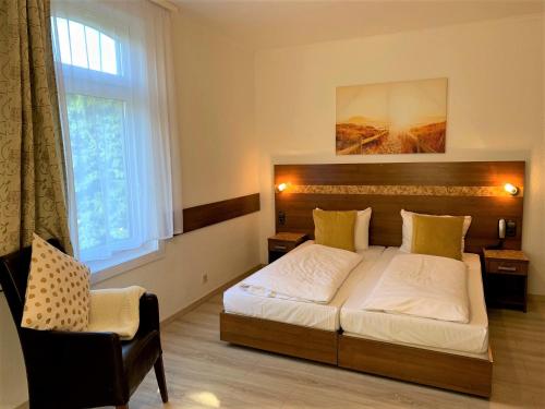 a bedroom with a large bed and a window at Hotel zum Adler in Bad Homburg vor der Höhe
