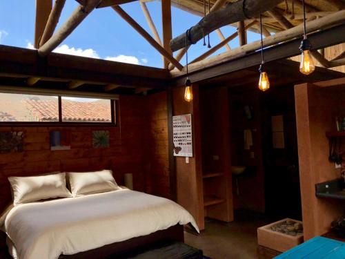 a bedroom with a bed in a room with a window at Portal de Iza in Iza