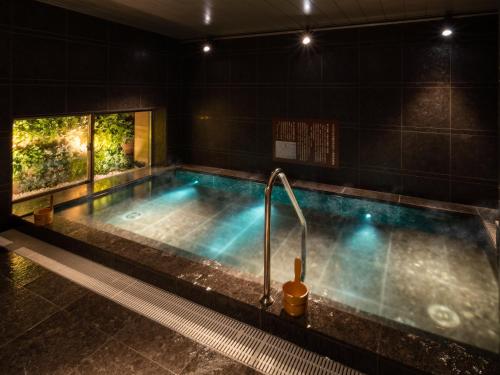 a jacuzzi tub in a dark room at Super Hotel Premier Ginza in Tokyo
