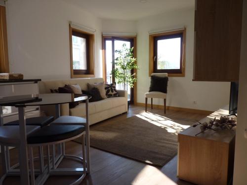 a living room with a couch and a table at Casa da Ponte in Mirandela