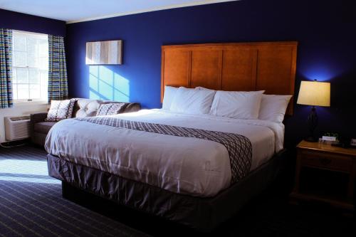 a bedroom with a large bed and a couch at The Lodge at Jackson Village in Jackson