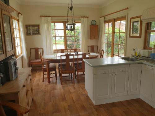 a kitchen and dining room with a table and chairs at Sutton Forest Cottage in Sutton Forest