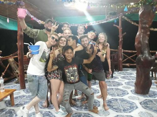 a group of people posing for a picture on a stage at Venus Resort in Haad Rin