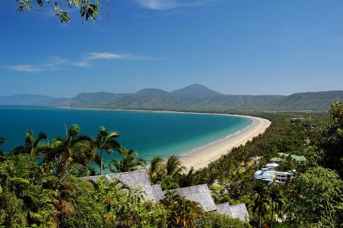 a view of a beach with palm trees and the ocean at Sonia's At Ramada Resort Free Wifi in Port Douglas