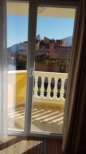 a sliding glass door with a view of a balcony at MARIANA - guest rooms in Gotse Delchev