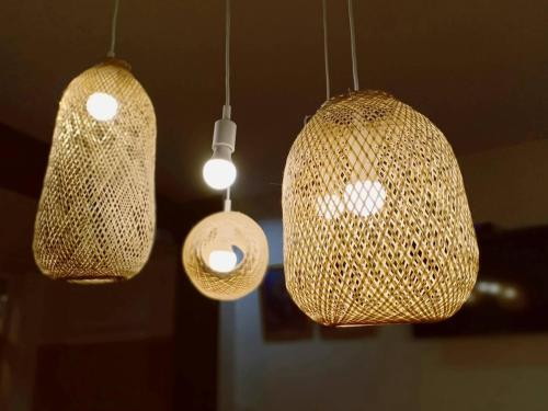 a group of three lights hanging from a ceiling at Khoksametchun Hostel in Hat Yai