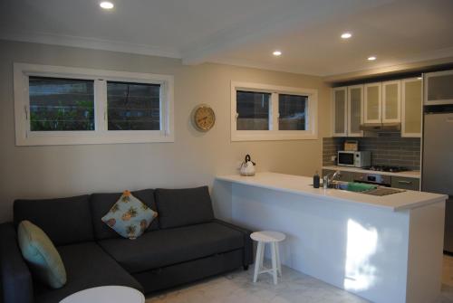 a living room with a couch and a kitchen at Victoria 53 in Brisbane