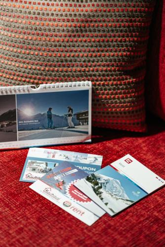 two cards sitting on a table next to a pillow at Appartment Venter Bergwelt in Vent
