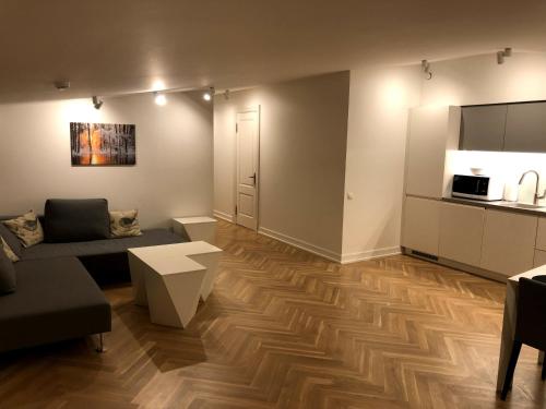 a living room with a couch and a kitchen at Great apartament in a heart of Tallinn in Tallinn