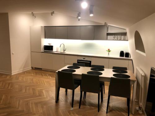 a kitchen with a table and chairs in a room at Great apartament in a heart of Tallinn in Tallinn