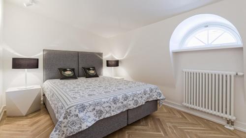 a bedroom with a bed and an arched window at Great apartament in a heart of Tallinn in Tallinn