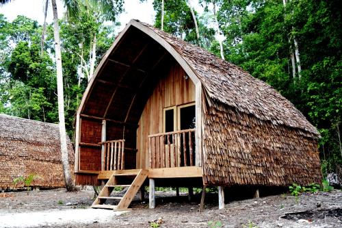 a small hut with a staircase in front of it at Tanjung Kalemo Resort in Batudaka