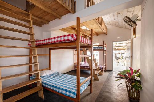 a room with bunk beds and a staircase at Bara Beach Home in Galle
