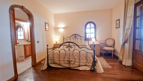 a bedroom with a bed and a table and chairs at Tenuta Cusmano in Grottaferrata